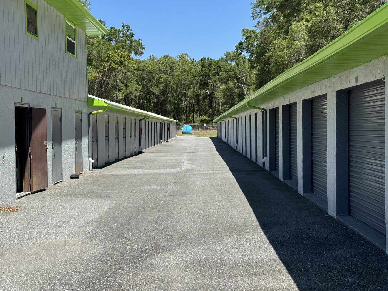 Wide paved drive aisle inside the gated Cortez Self Storage lot in Brooksville, FL — plenty of clearance to maneuver an RV or fifth wheel.